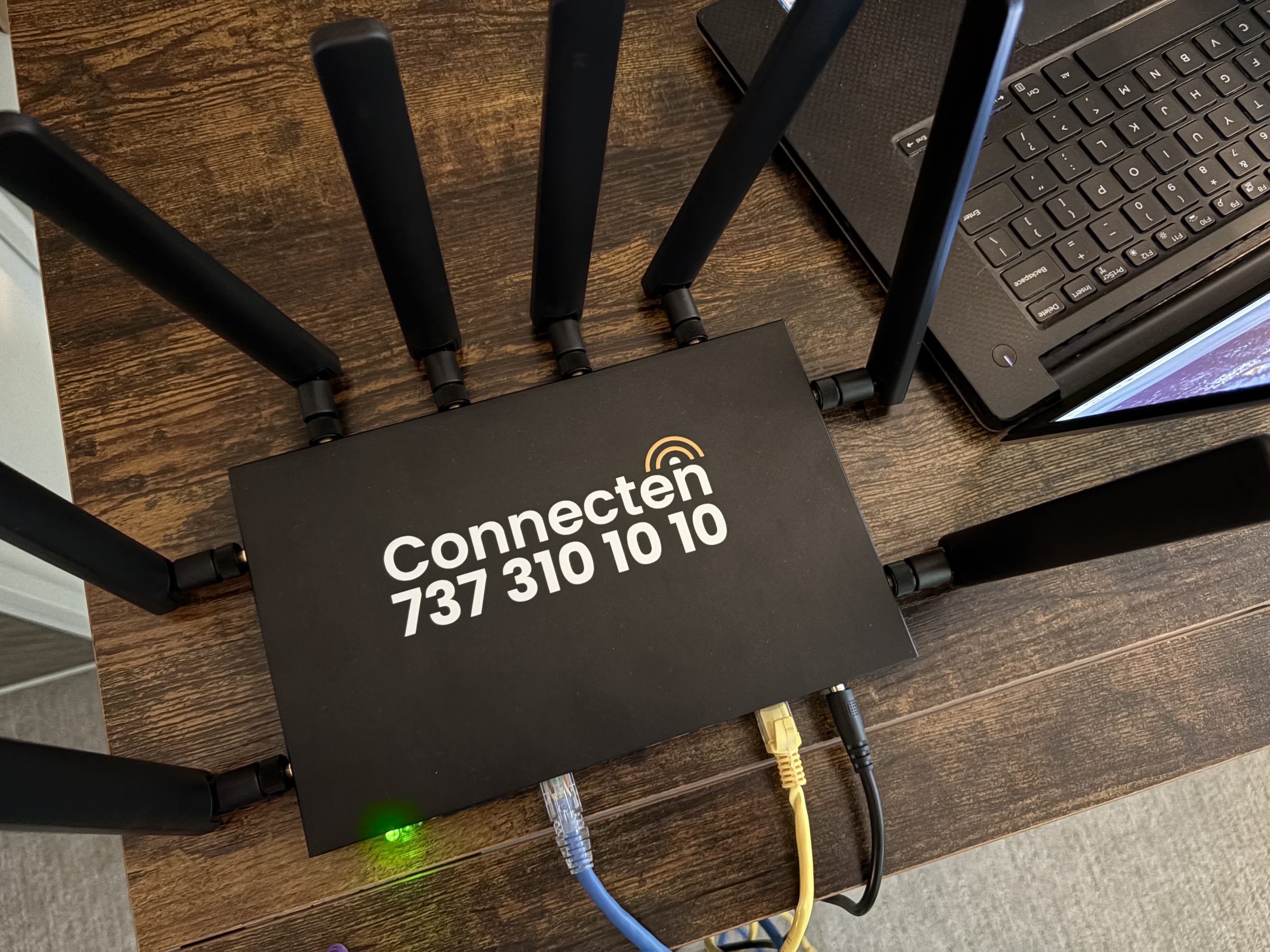 Connecten multi-carrier router top-down view showing four antennas on a desk
